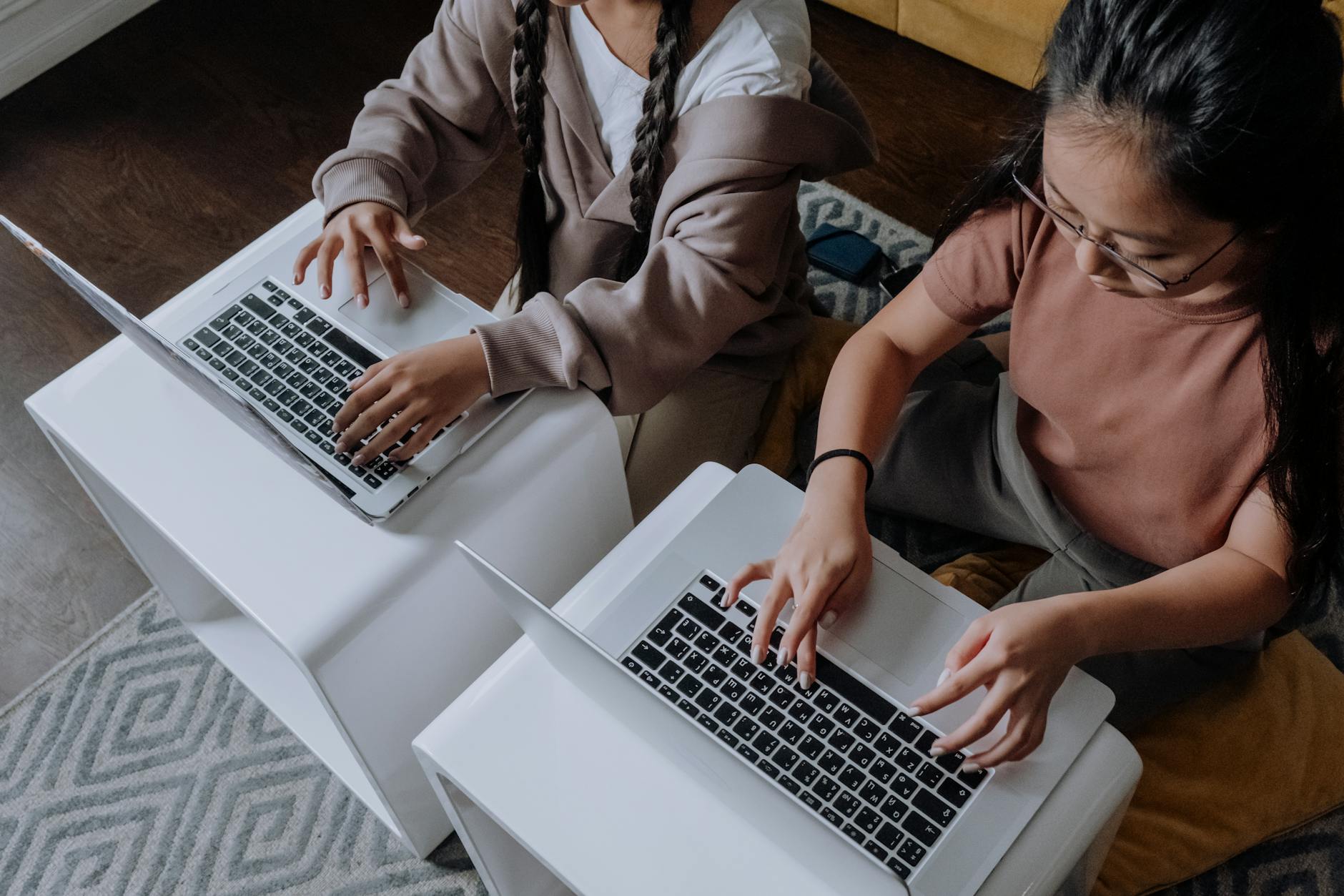 overhead shot of a children using laptop together